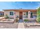 Tan brick home with a covered porch, small yard, and mature shrubs at 131 W Tulsa St, Chandler, AZ 85225