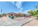 Single story home with carport, gravel driveway and mature trees at 131 W Tulsa St, Chandler, AZ 85225