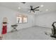 Bright living room with tile floors, white walls, and a ceiling fan at 131 W Tulsa St, Chandler, AZ 85225