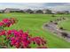 Landscaped golf course with water feature and homes in the background at 9904 E Monterey Ave, Mesa, AZ 85209