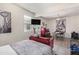 Small bedroom with a red couch and city skyline artwork at 4809 E Fire Opal Ln, San Tan Valley, AZ 85143
