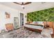 Main bedroom with leafy wallpaper, wooden bed frame and a cozy sitting area at 4809 E Fire Opal Ln, San Tan Valley, AZ 85143