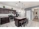 Modern kitchen with dark cabinets, granite countertops, and stainless steel appliances at 4809 E Fire Opal Ln, San Tan Valley, AZ 85143