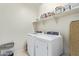 Laundry room with washer, dryer, and ample shelving at 4809 E Fire Opal Ln, San Tan Valley, AZ 85143