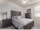 Cozy bedroom with a rustic wooden bed frame and dresser at 4809 E Fire Opal Ln, San Tan Valley, AZ 85143