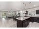 Open concept kitchen with large island, granite countertops, and stainless steel appliances at 4809 E Fire Opal Ln, San Tan Valley, AZ 85143