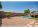 Landscaped backyard with a pool, patio, and gravel at 4809 E Fire Opal Ln, San Tan Valley, AZ 85143