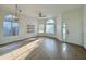 Bright living room with vinyl flooring, ceiling fan, and large windows at 4423 E Ponca St, Phoenix, AZ 85044