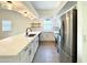Modern kitchen with white cabinets, quartz countertops, and stainless steel appliances at 4423 E Ponca St, Phoenix, AZ 85044