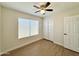 Well-lit bedroom with wood-look floors and double-door closet at 4423 E Ponca St, Phoenix, AZ 85044