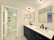 Elegant bathroom with dual vanities, quartz countertops, and a large shower at 4423 E Ponca St, Phoenix, AZ 85044