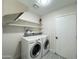 Bright laundry room with washer, dryer, and shelving at 4423 E Ponca St, Phoenix, AZ 85044