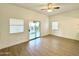 Spacious bedroom with wood-look floors and sliding glass door to patio at 4423 E Ponca St, Phoenix, AZ 85044