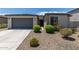 Single story home with two-car garage and desert landscaping at 19031 W Palo Verde Dr, Litchfield Park, AZ 85340