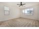 Spacious bedroom with neutral carpet and large windows at 19031 W Palo Verde Dr, Litchfield Park, AZ 85340