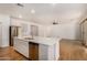 Kitchen island with white quartz countertop, stainless steel dishwasher, and double sink at 19031 W Palo Verde Dr, Litchfield Park, AZ 85340