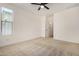 Bright bedroom with ceiling fan and neutral carpeting at 19031 W Palo Verde Dr, Litchfield Park, AZ 85340
