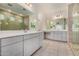 Double vanity bathroom with gray cabinets and a large mirror at 19031 W Palo Verde Dr, Litchfield Park, AZ 85340