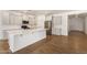 Modern kitchen with island, stainless steel appliances, and light cabinets at 19031 W Palo Verde Dr, Litchfield Park, AZ 85340
