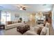 Virtually staged living room with open floor plan and kitchen view at 42468 W Palmyra Ln, Maricopa, AZ 85138