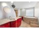 Modern bathroom with a large soaking tub, walk-in shower, and red vanity at 6639 E Sharon Dr, Scottsdale, AZ 85254