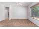 Bright bedroom with neutral walls, carpeting, and a view of the bathroom at 10908 E Olla Ave, Mesa, AZ 85212