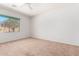 Spacious bedroom with neutral carpeting and a large window at 10908 E Olla Ave, Mesa, AZ 85212