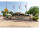 Sunland Springs Golf Club entrance sign with flags and golf cart crossing sign at 10908 E Olla Ave, Mesa, AZ 85212