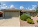 House exterior showcasing a two-car garage and attractive landscaping at 10908 E Olla Ave, Mesa, AZ 85212