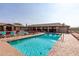 Community pool with multiple lounge chairs and covered patio area at 10908 E Olla Ave, Mesa, AZ 85212