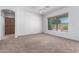 Spacious bedroom with neutral carpeting and large window at 10908 E Olla Ave, Mesa, AZ 85212
