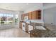 Bright kitchen features granite countertops, wood cabinets, and modern appliances at 10908 E Olla Ave, Mesa, AZ 85212