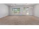 Bright living room featuring neutral carpeting and access to backyard at 10908 E Olla Ave, Mesa, AZ 85212