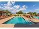 Community pool area with lounge chairs and covered seating at 10908 E Olla Ave, Mesa, AZ 85212