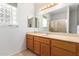 Clean bathroom with wood vanity, large mirror, and a shower at 10908 E Olla Ave, Mesa, AZ 85212