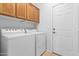 Laundry room with washer, dryer, and wood cabinets at 10908 E Olla Ave, Mesa, AZ 85212