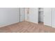 Simple bedroom with neutral carpet, closet, and door to laundry room at 10908 E Olla Ave, Mesa, AZ 85212