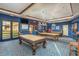 Billiards room with two pool tables and comfortable seating at 41650 W Harvest Moon Dr, Maricopa, AZ 85138