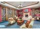 Community library with a fireplace and comfortable seating at 41650 W Harvest Moon Dr, Maricopa, AZ 85138