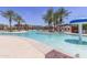 Community pool with a fun water feature at 41650 W Harvest Moon Dr, Maricopa, AZ 85138