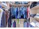 Large closet with hanging clothes and storage shelves at 6786 W Gelding Ln, Coolidge, AZ 85128