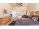 Primary bedroom with large bed, dresser and access to bathroom at 6786 W Gelding Ln, Coolidge, AZ 85128