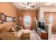 Cozy living room featuring leather sofas and a wood-beamed ceiling at 6786 W Gelding Ln, Coolidge, AZ 85128