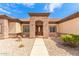 Elegant entryway with a stone facade and a wood door at 6786 W Gelding Ln, Coolidge, AZ 85128
