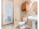 Bathroom with toilet, sink, shower, and built-in shelving at 6786 W Gelding Ln, Coolidge, AZ 85128
