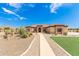Single story home with desert landscaping and walkway at 6786 W Gelding Ln, Coolidge, AZ 85128