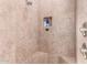 Walk-in shower with built-in seat and multiple shower heads at 6786 W Gelding Ln, Coolidge, AZ 85128