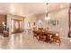 Bright dining room with a wood table and access to the entryway at 6786 W Gelding Ln, Coolidge, AZ 85128