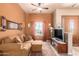 Small living room with a sofa and a view of the backyard at 6786 W Gelding Ln, Coolidge, AZ 85128