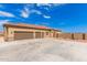 House exterior featuring a three-car garage and large driveway at 6786 W Gelding Ln, Coolidge, AZ 85128